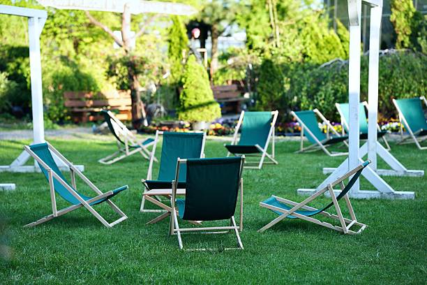 Folding lounge chairs on the green lawn.