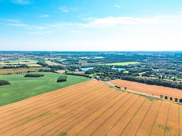 istock Drone capturing stunning wheat fields and green meadows in english countryside 2220029977