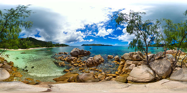 istock Rocky shoreline with crystal-clear waters and distant islands. Praslin, Seychelles. 2220031557