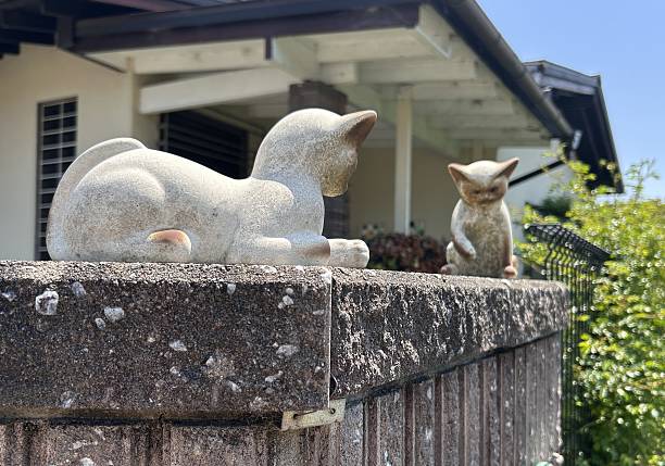 istock Small cat sculpture on a fence top 2220034231