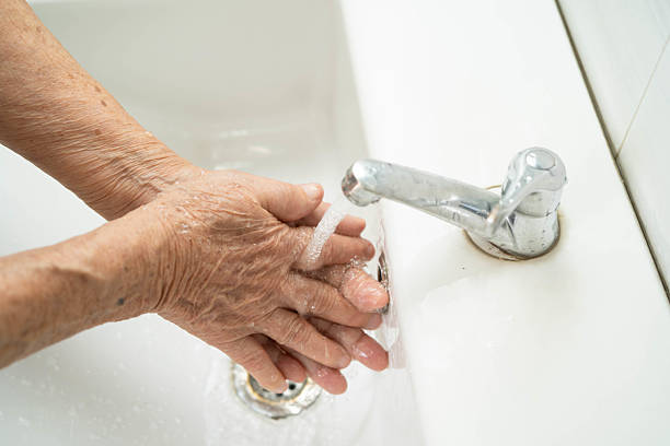 istock Asian elderly woman washing hands in bathroom. 2220038962
