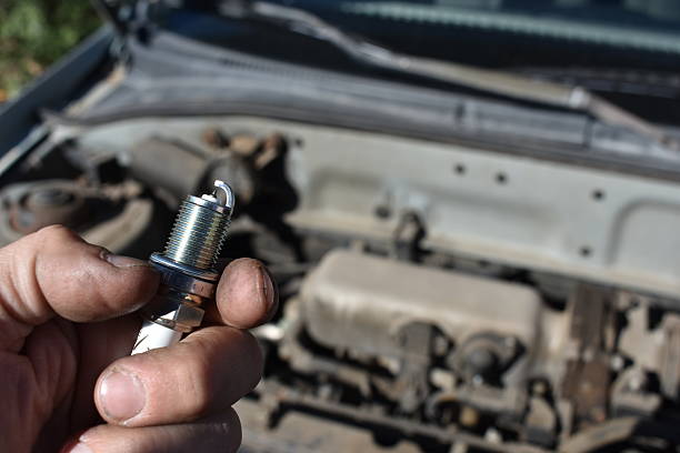 istock Working on Car Changing Spark Plugs Under the Hood 2220042762