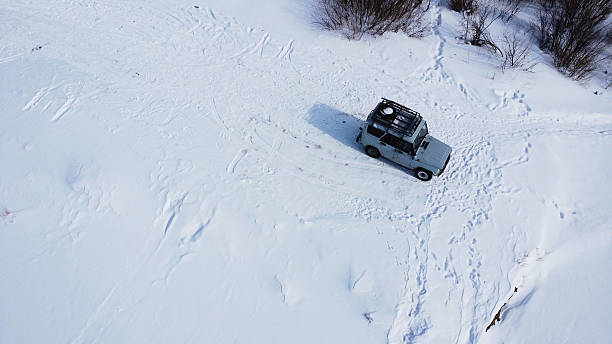 snow-covered passenger car, winter day, cyclone