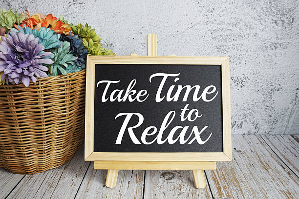 istock Take Time to Relax text message on easel blackboard standing on wooden background 2220046538