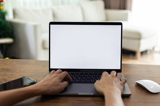 istock mock up businessman working empty screen computer on wood desk in home. Notebook Laptop with blank screen 2220049946