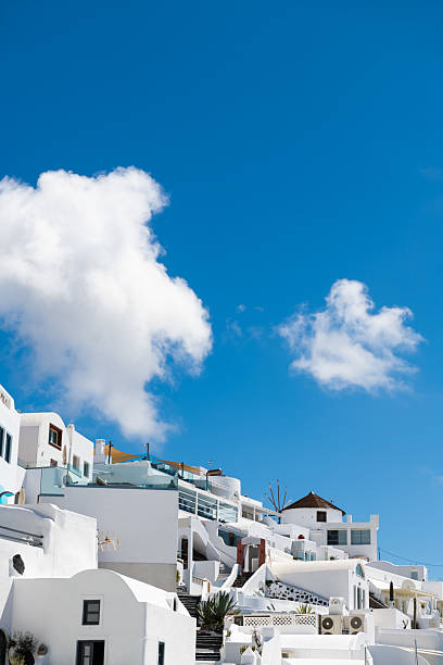 White cycladic architecture in Santorini island, Greece. Blue sky with white clouds at sunny day