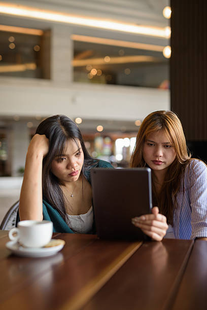 istock Two young woman together in cafe restaurant 2220062456