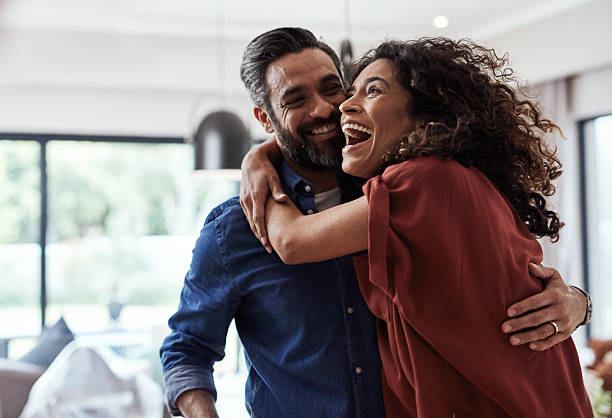 istock Happy Couple Embracing in a Bright and Modern Living Space 2220064748
