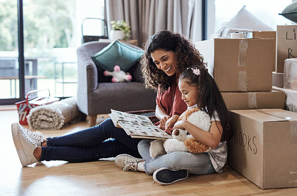 istock Mother and Daughter Bonding While Unpacking in Their New Home 2220064760