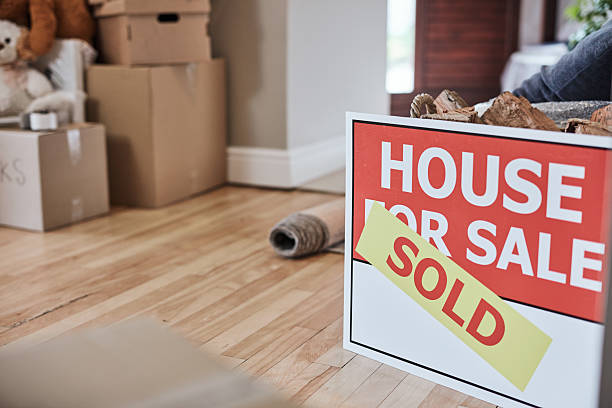 istock Moving Day With Sold Sign in a New Home Interior 2220064794