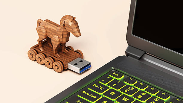 istock Trojan horse shaped usb stick moving through a laptop computer 2220068815