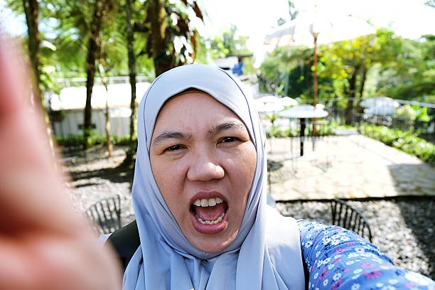 istock POV: Woman Reacts to Device Screen 2220071137