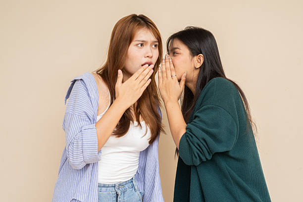 istock Portrait of two young women against plain wall 2220071156