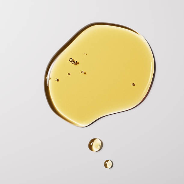 istock Argan oil liquid texture minimalist background 3d rendering, yellow serum drops on white, natural cosmetic concept. 2220071172