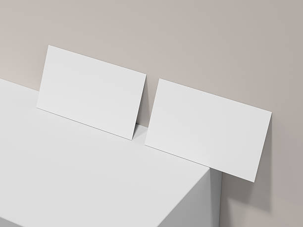 istock Two clean business cards leaning against soft blue wall mockup 2220071402