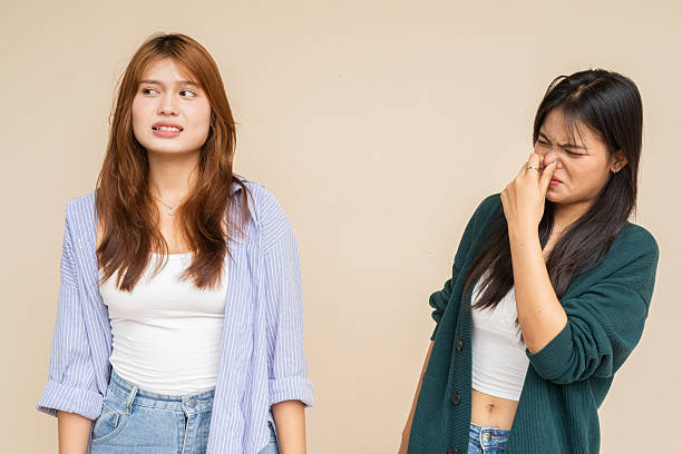 istock Portrait of two young women against plain wall 2220071683