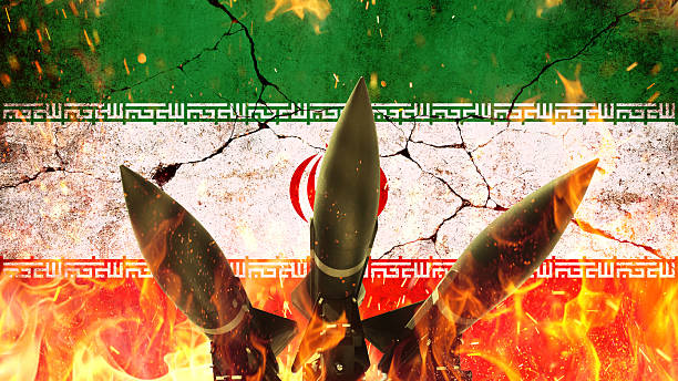 istock Grunge Iranian flag with nuclear missiles, fire and sparks with cracks and distressed texture, conflict concept. Distressed Iranian flag with deep fractures, illustrating instability or crisis. War 2220072381