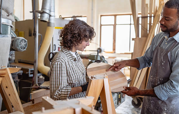 istock Cheerful Multiracial Carpenters Collaborating in Bright Workshop with Wooden Projects 2220074390