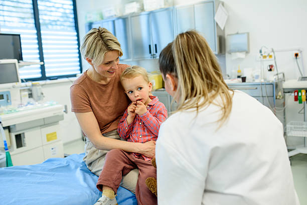 istock Pediatrician talking little boy during preventive health check up. 2220076578