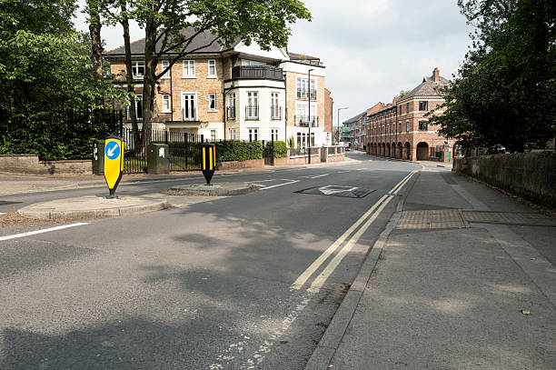 Typical British street showing speed reduction measures on the tarmac road.