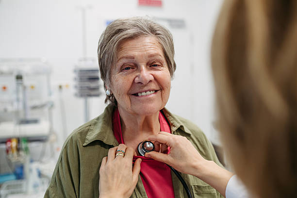 istock Geriatrician doctor examining elderly patient with stethoscope. 2220076858