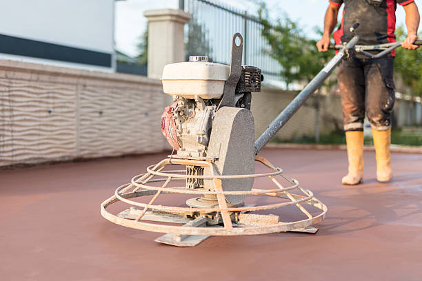 istock Man polishing and leveling cement screed mortar floors at the construction site 2220077586