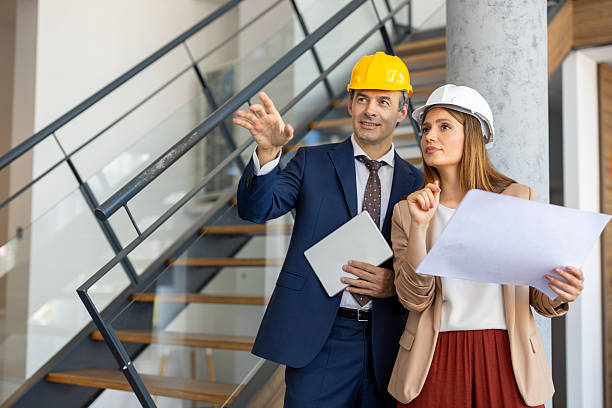 istock Architects discussing blueprint in modern office building 2220077884