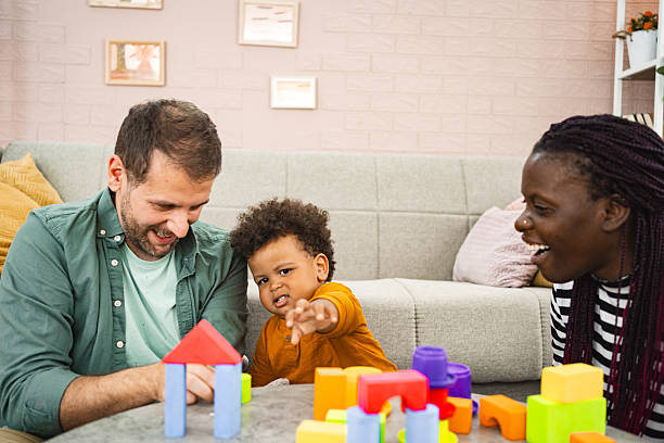 istock Happy multi-racial family playing with building blocks at home 2220079192