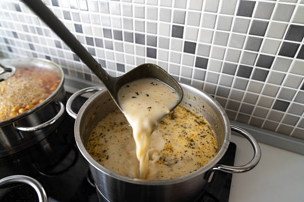 Velvety green soup topped with spears, cream swirl, and toasted bread