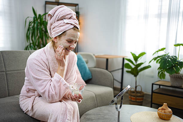 istock Young Woman Applying a Face Mask at Home 2220080013