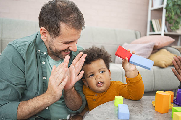 istock Father and toddler son playing with building blocks at home 2220081200