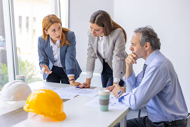 istock Architects and engineers discussing plans in a meeting 2220082900