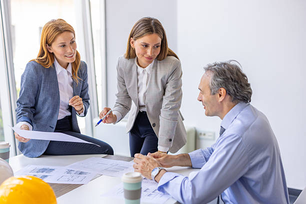 istock Architects discussing blueprint in a meeting room 2220082972