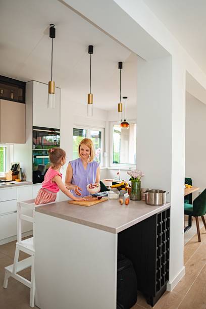 istock Mother and daughter preparing healthy meal in modern kitchen 2220088023