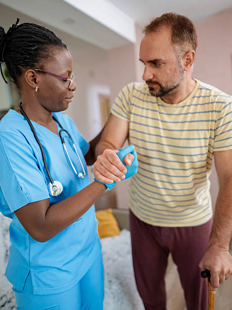 istock Nurse assisting patient with walking stick in nursing home 2220089592