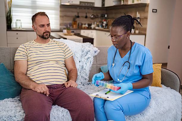 istock Nurse explaining medicine dosage to her male patient at home 2220089607