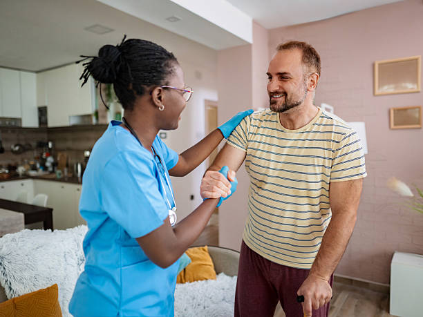 istock Nurse assisting a patient using a walking cane at home 2220089687