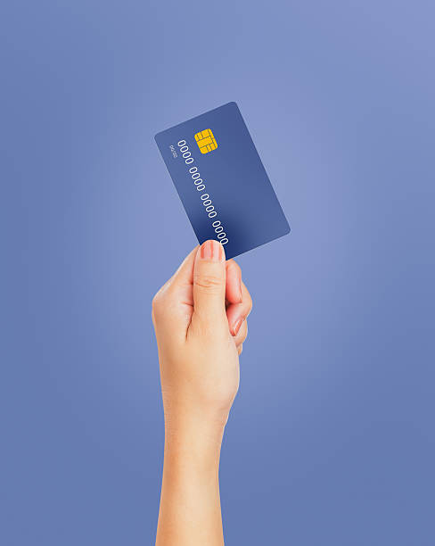 istock Hand hold credit card isolated on blue background. 2220089763