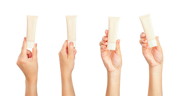 Female hand holding blank cosmetic bottle isolated on white background, clipping path.