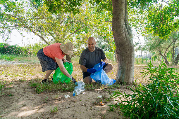 istock Volunteers collecting garbage in the forest 2220090257
