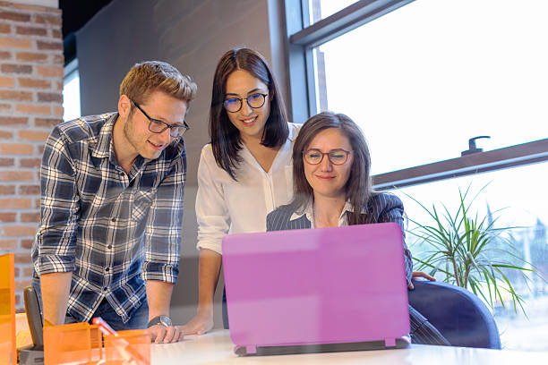 istock Young Team Collaborating on Laptop with Consultant in Modern Office Setting 2220093144
