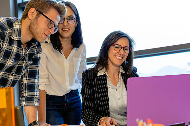 istock Young Couple Consulting with Female Professional in Modern Office Setting 2220093186