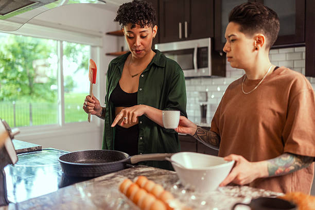 istock Lesbian loving couple preparing breakfast together in the kitchen 2220094836