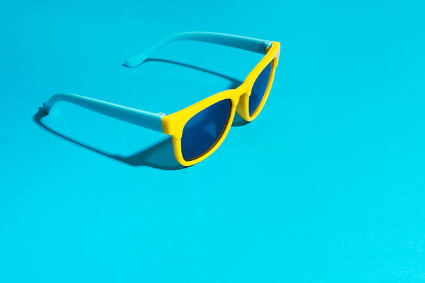 istock Plastic sunglasses on turquoise blue background in perspective with hard shadow 2220096161