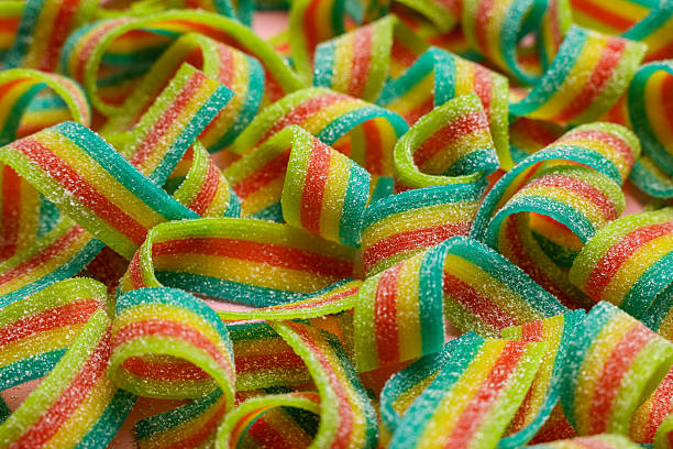 istock Tasty rainbow sour belts on pink background, closeup 2220096824