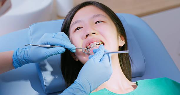 istock Asian dentist exame teenage braces status 2220097324