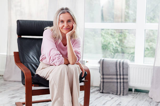 istock Happy middle aged Woman sits at Home 2220101438