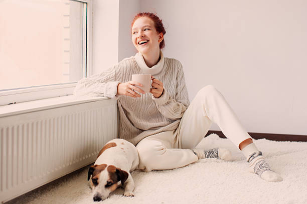 istock Young Woman Drinking hot coffee at white room 2220102038