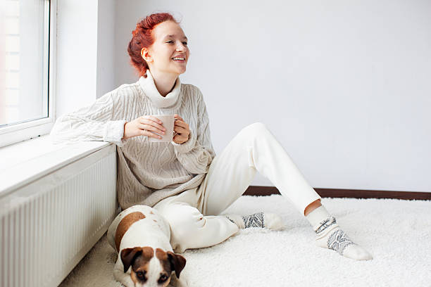 istock Young Woman Drinking hot coffee at white room 2220102041