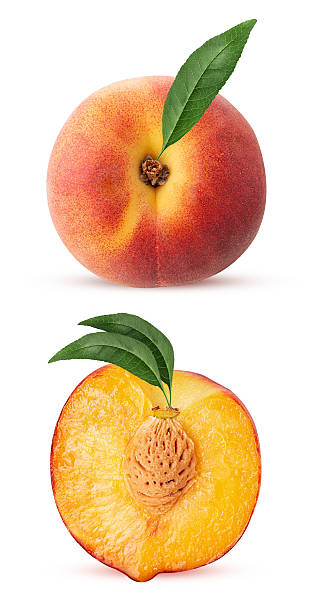 istock Peach fruit whole one cut in half with green leaf 2220107262